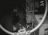 On-board radiotelegraphist who records a reception in the logbook. Taken from the film Luce.